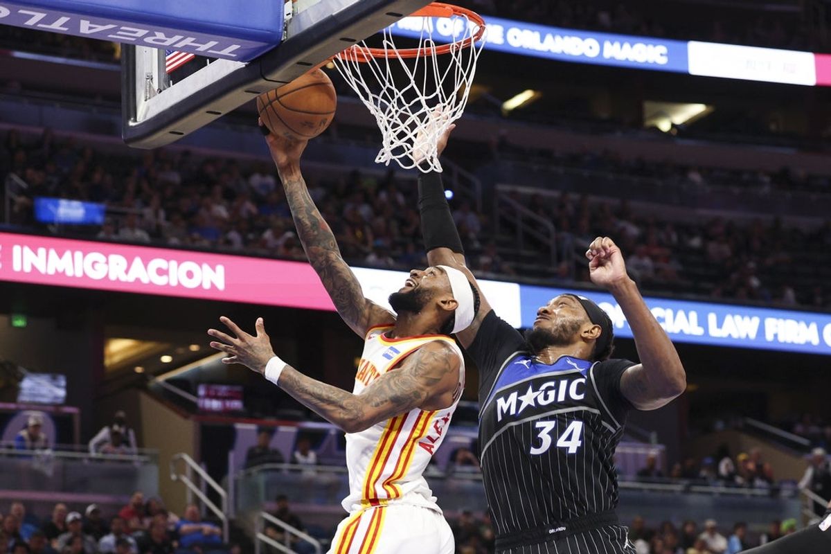 Apr 1, 2026; Orlando, Florida, USA; Atlanta Hawks guard Nickeil Alexander-Walker (7) drives to the basket past Orlando Magic center Wendell Carter Jr. (34) in the second quarter at Kia Center. Mandatory Credit: Nathan Ray Seebeck-Imagn Images