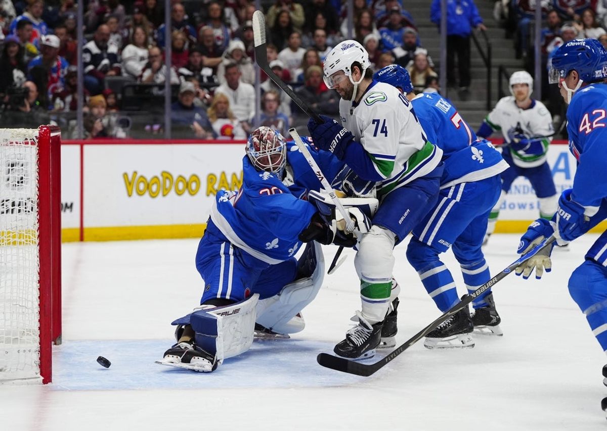 Apr 1, 2026; Denver, Colorado, USA; Vancouver Canucks left wing Jake DeBrusk (74) scores on Colorado Avalanche goaltender MacKenzie Blackwood (39) in the first period at Ball Arena. Mandatory Credit: Ron Chenoy-Imagn Images