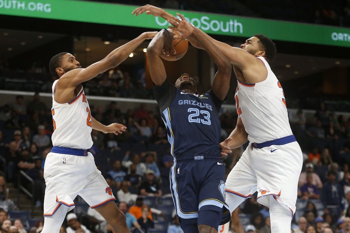 Apr 1, 2026; Memphis, Tennessee, USA; Memphis Grizzlies forward Cedric Coward (23) drives to the basket between New York Knicks guard Mikal Bridges (25) and center Karl-Anthony Towns (32) during the fourth quarter at FedExForum. Mandatory Credit: Petre Thomas-Imagn Images