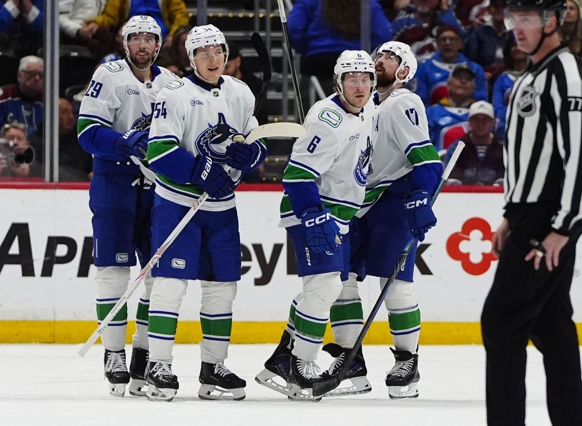 Apr 1, 2026; Denver, Colorado, USA; Members of the Vancouver Canucks celebrate a third period empty net goal by right wing Brock Boeser (6) against the Colorado Avalanche at Ball Arena. Mandatory Credit: Ron Chenoy-Imagn Images