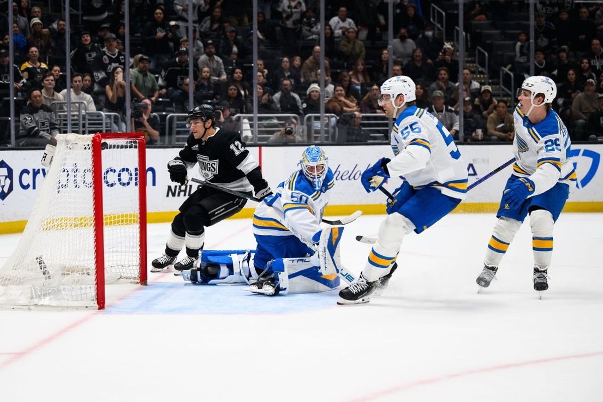 Apr 1, 2026; Los Angeles, California, USA; Los Angeles Kings left wing Trevor Moore (12) shoots the game-winning goal during overtime against the St. Louis Blues at Crypto.com Arena. Mandatory Credit: William Liang-Imagn Images