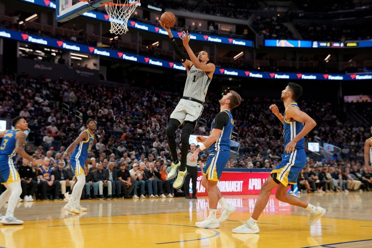 Apr 1, 2026; San Francisco, California, USA; San Antonio Spurs center Victor Wembanyama (1) makes a layup in front of Golden State Warriors guard Pat Spencer (61) in the third quarter at the Chase Center. Mandatory Credit: Cary Edmondson-Imagn Images