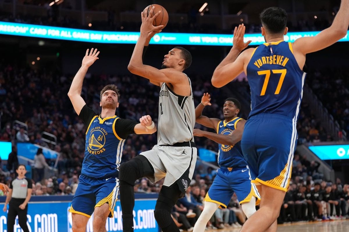 Apr 1, 2026; San Francisco, California, USA; San Antonio Spurs center Victor Wembanyama (1) drives to the hoop between Golden State Warriors guard Pat Spencer (61) and center Omer Yurtseven (77) in the fourth quarter at the Chase Center. Mandatory Credit: Cary Edmondson-Imagn Images