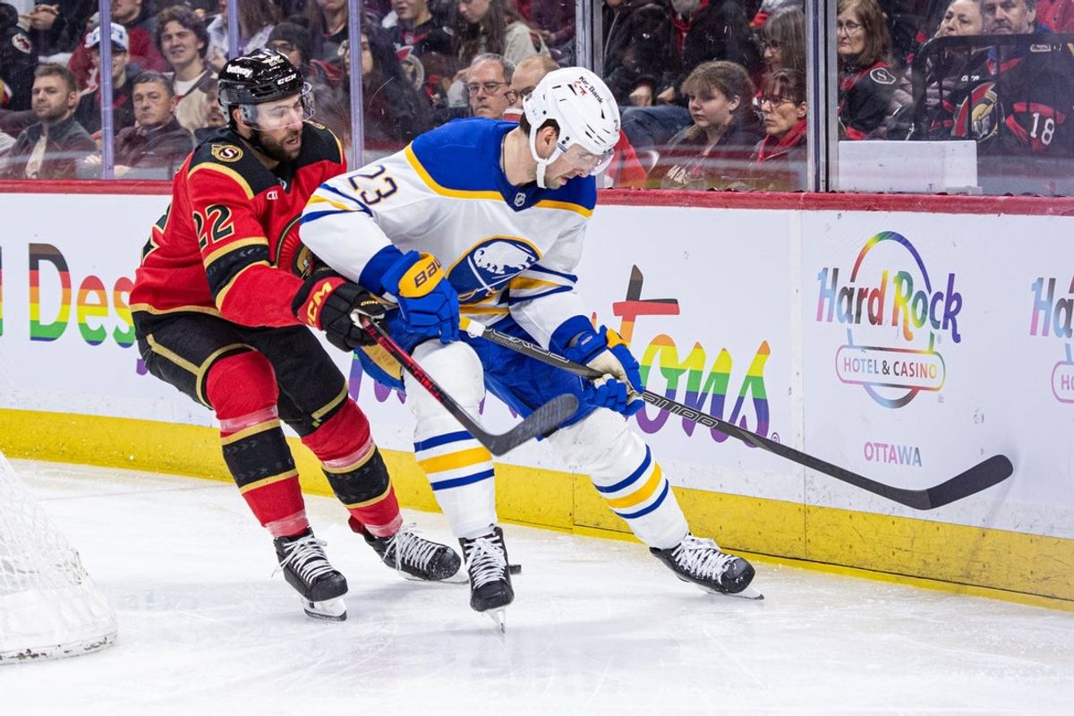Apr 2, 2026; Ottawa, Ontario, CAN; Ottawa Senators right wing Michael Amadio (22) and Buffalo Sabres defenseman Mattias Samuelsson (23) battle for the puck in the first period at the Canadian Tire Centre. Mandatory Credit: Marc DesRosiers-IMAGN Images