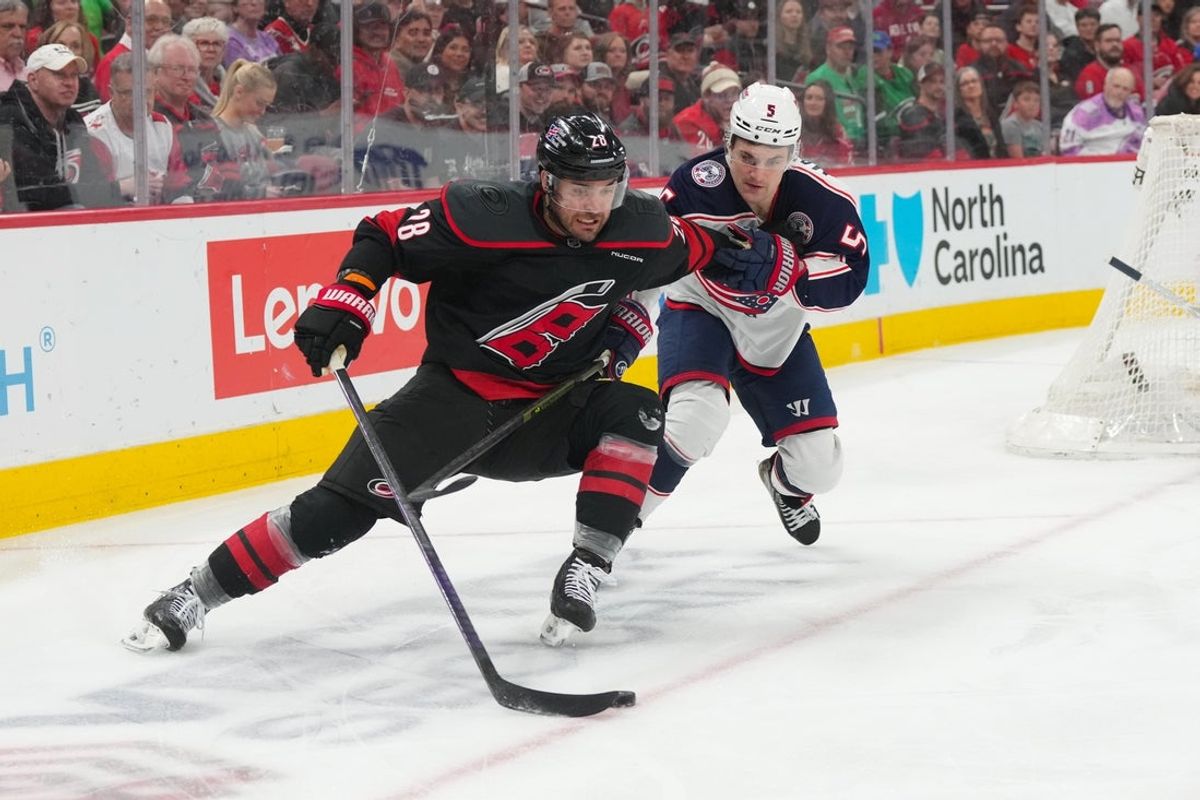 Apr 2, 2026; Raleigh, North Carolina, USA;  Carolina Hurricanes left wing William Carrier (28) skates with the puck against Columbus Blue Jackets defenseman Denton Mateychuk (5) during the first period at Lenovo Center. Mandatory Credit: James Guillory-Imagn Images