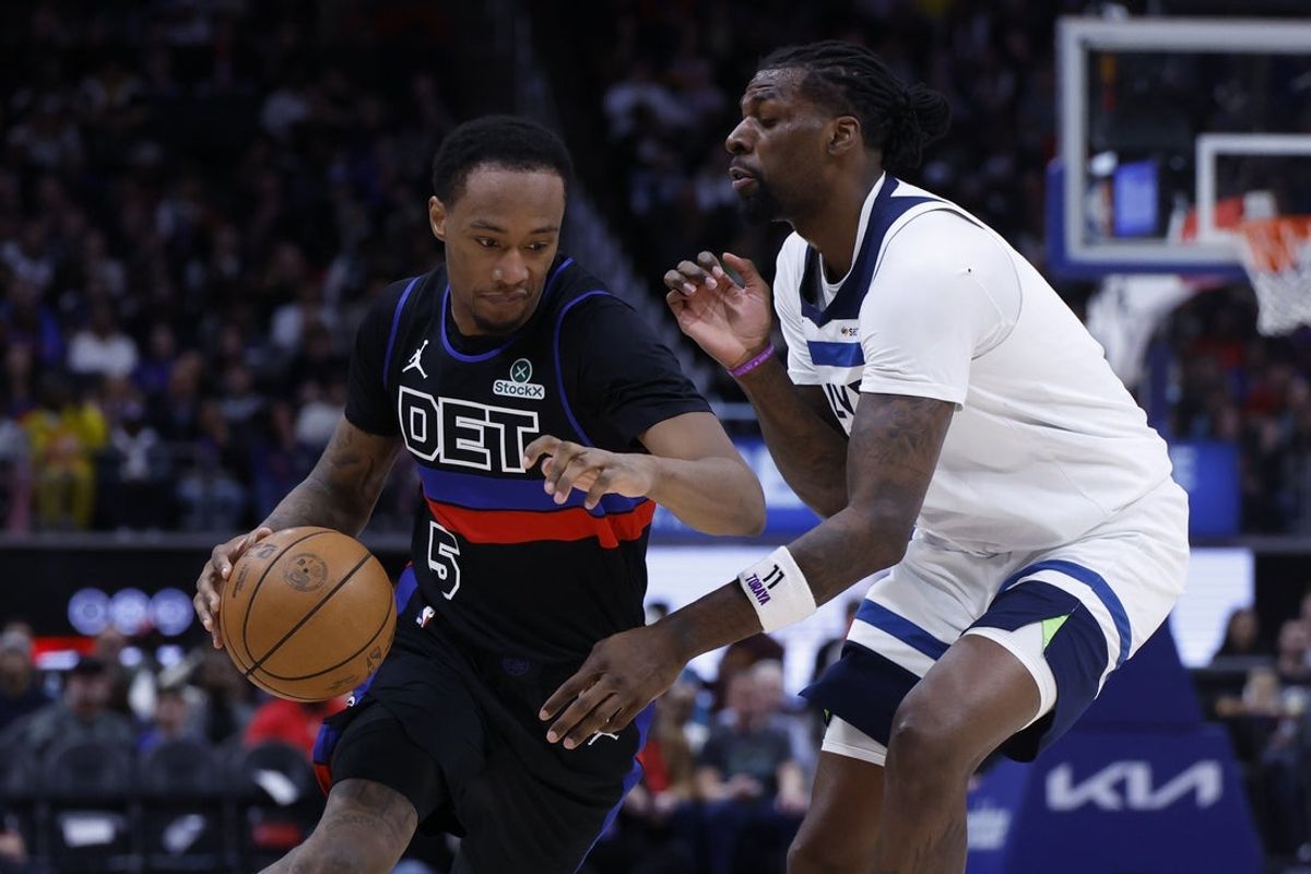 Apr 02, 2026; Detroit, Michigan, USA; Detroit Pistons forward Ronald Holland II (5) dribbles defended by Minnesota Timberwolves center Naz Reid (11) in the first half at Little Caesars Arena. Mandatory Credit: Rick Osentoski-Imagn Images