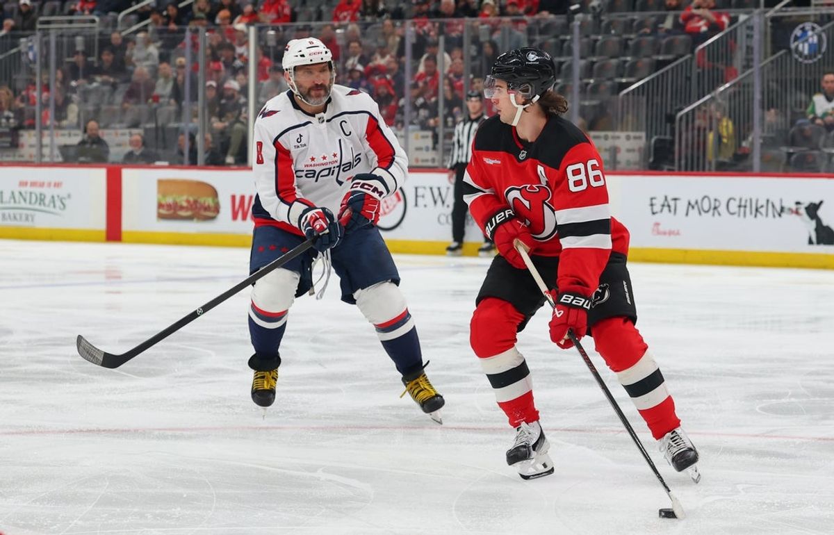 Apr 2, 2026; Newark, New Jersey, USA; New Jersey Devils center Jack Hughes (86) skates with the puck as Washington Capitals left wing Alex Ovechkin (8) defends during the first period at Prudential Center. Mandatory Credit: Ed Mulholland-Imagn Images
