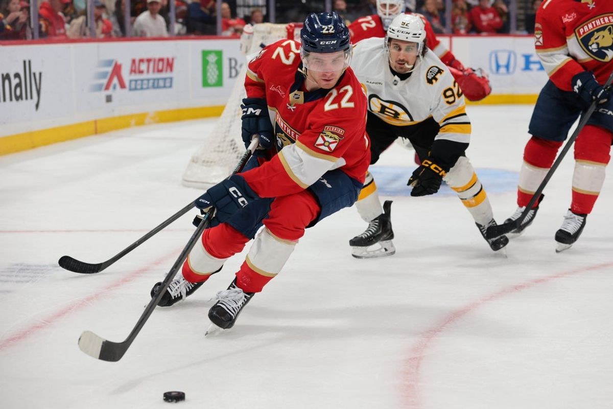 Apr 2, 2026; Sunrise, Florida, USA; Florida Panthers defenseman Tobias Bjornfot (22) moves the puck against Boston Bruins center Marat Khusnutdinov (92) during the second period at Amerant Bank Arena. Mandatory Credit: Sam Navarro-Imagn Images