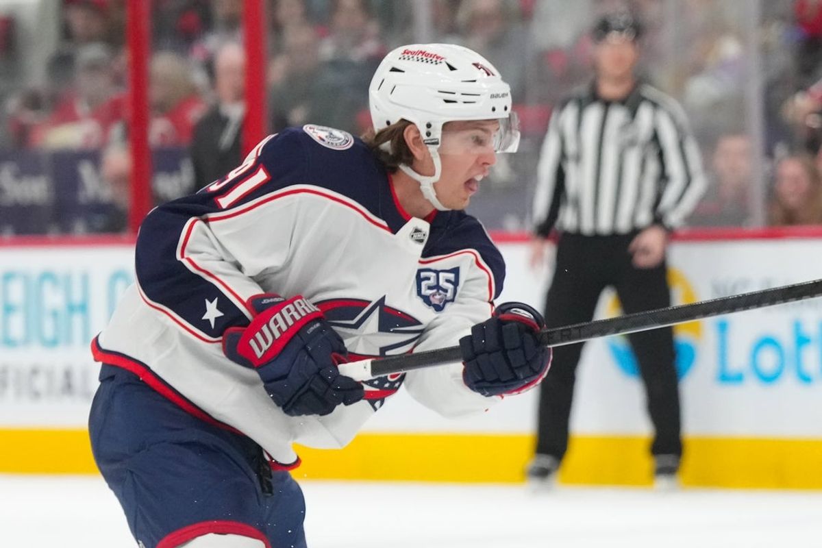 Apr 2, 2026; Raleigh, North Carolina, USA;  Columbus Blue Jackets center Kent Johnson (91) takes a shot against the Carolina Hurricanes during the second period at Lenovo Center. Mandatory Credit: James Guillory-Imagn Images