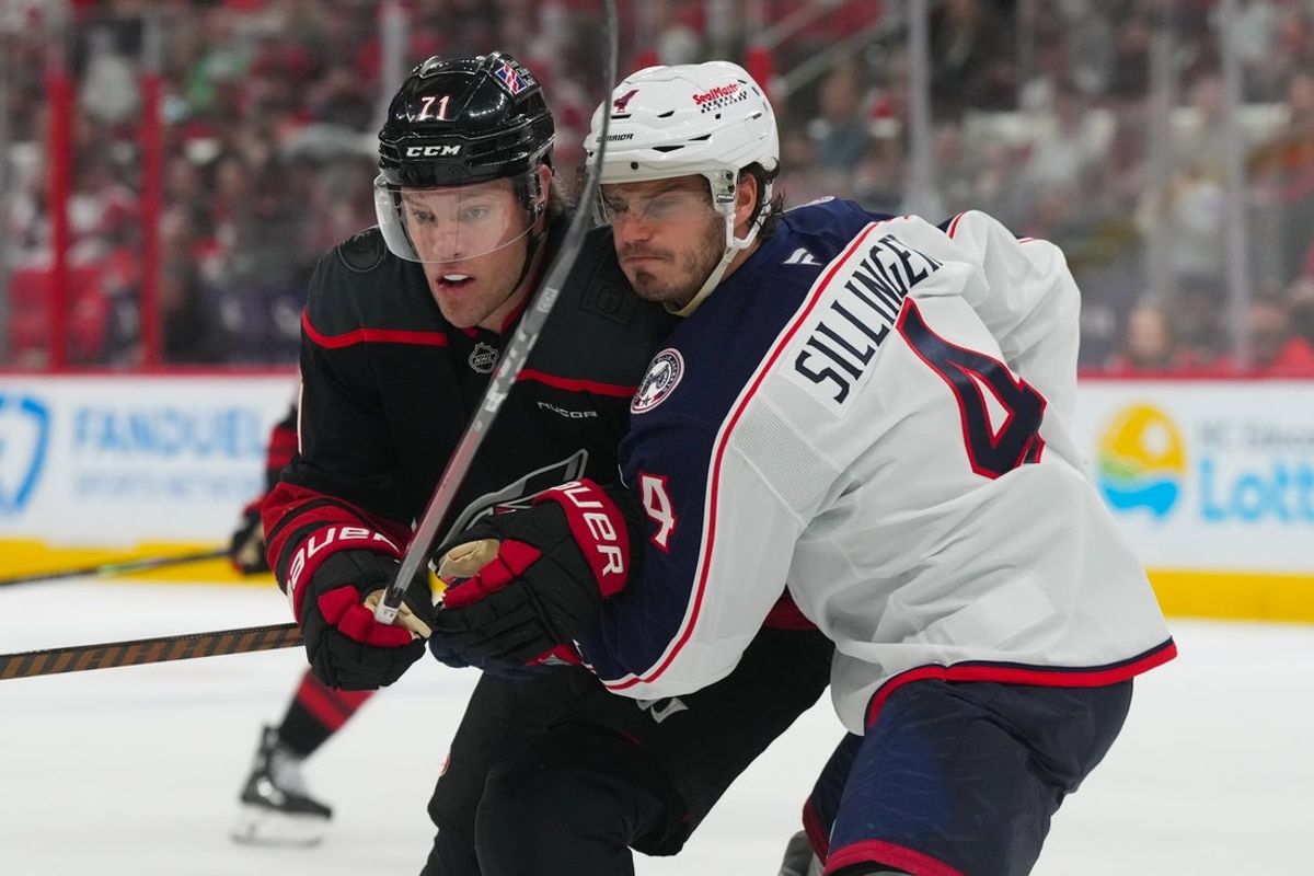Apr 2, 2026; Raleigh, North Carolina, USA;  Columbus Blue Jackets center Cole Sillinger (4) and Carolina Hurricanes left wing Taylor Hall (71) watch the play during the third period at Lenovo Center. Mandatory Credit: James Guillory-Imagn Images
