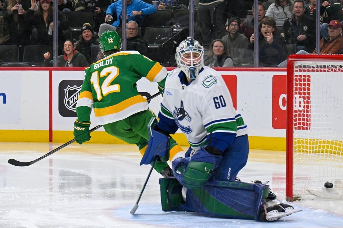 Apr 2, 2026; Saint Paul, Minnesota, USA;  Minnesota Wild forward Matt Boldy (12) beats Vancouver Canucks goalie Nikita Tolopilo (60) for his second goal of the game during the second period at Grand Casino Arena. Mandatory Credit: Nick Wosika-Imagn Images