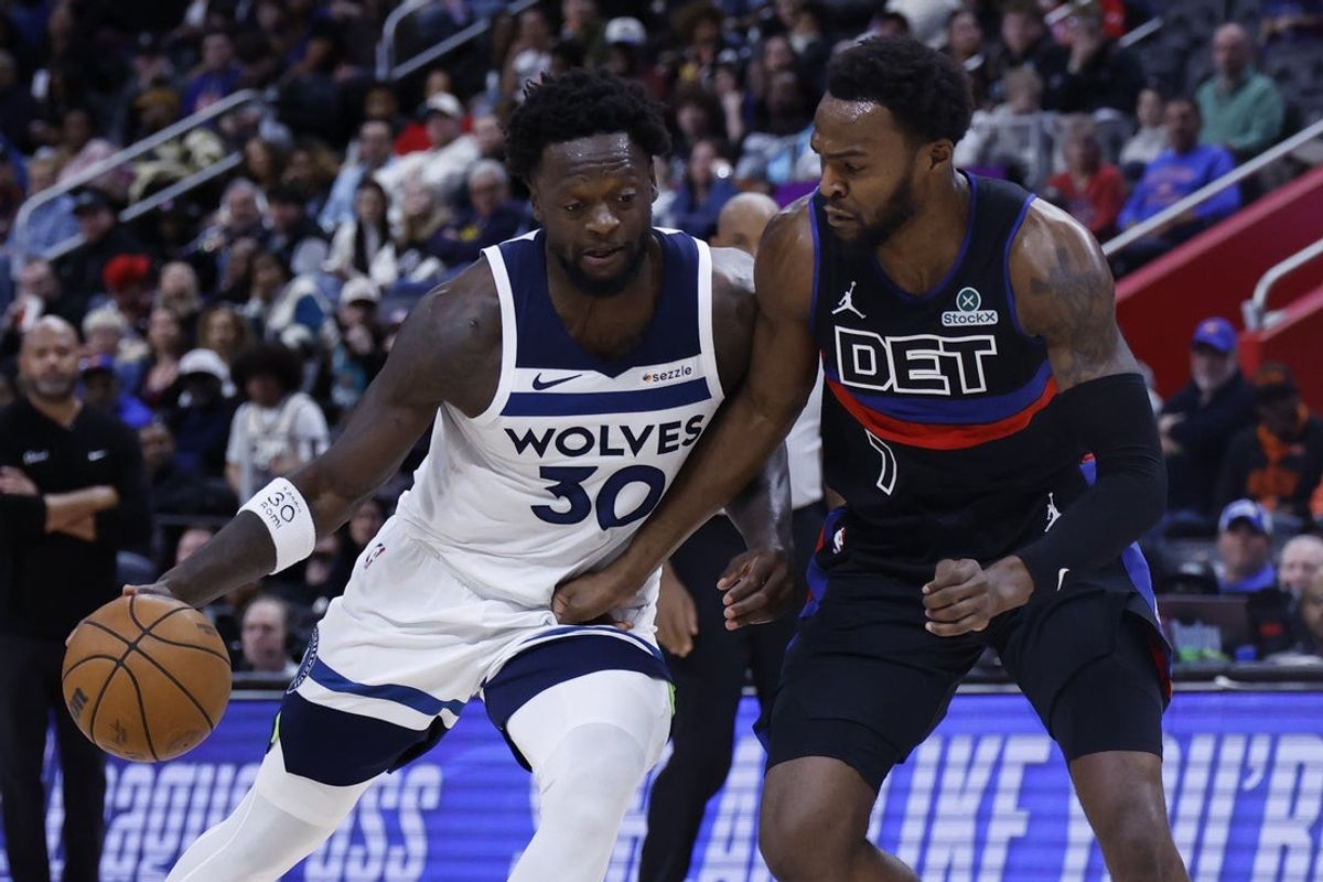 Apr 2, 2026; Detroit, Michigan, USA;  Minnesota Timberwolves forward Julius Randle (30) is defended by Detroit Pistons forward Paul Reed (7) in the second half t Little Caesars Arena. Mandatory Credit: Rick Osentoski-Imagn Images