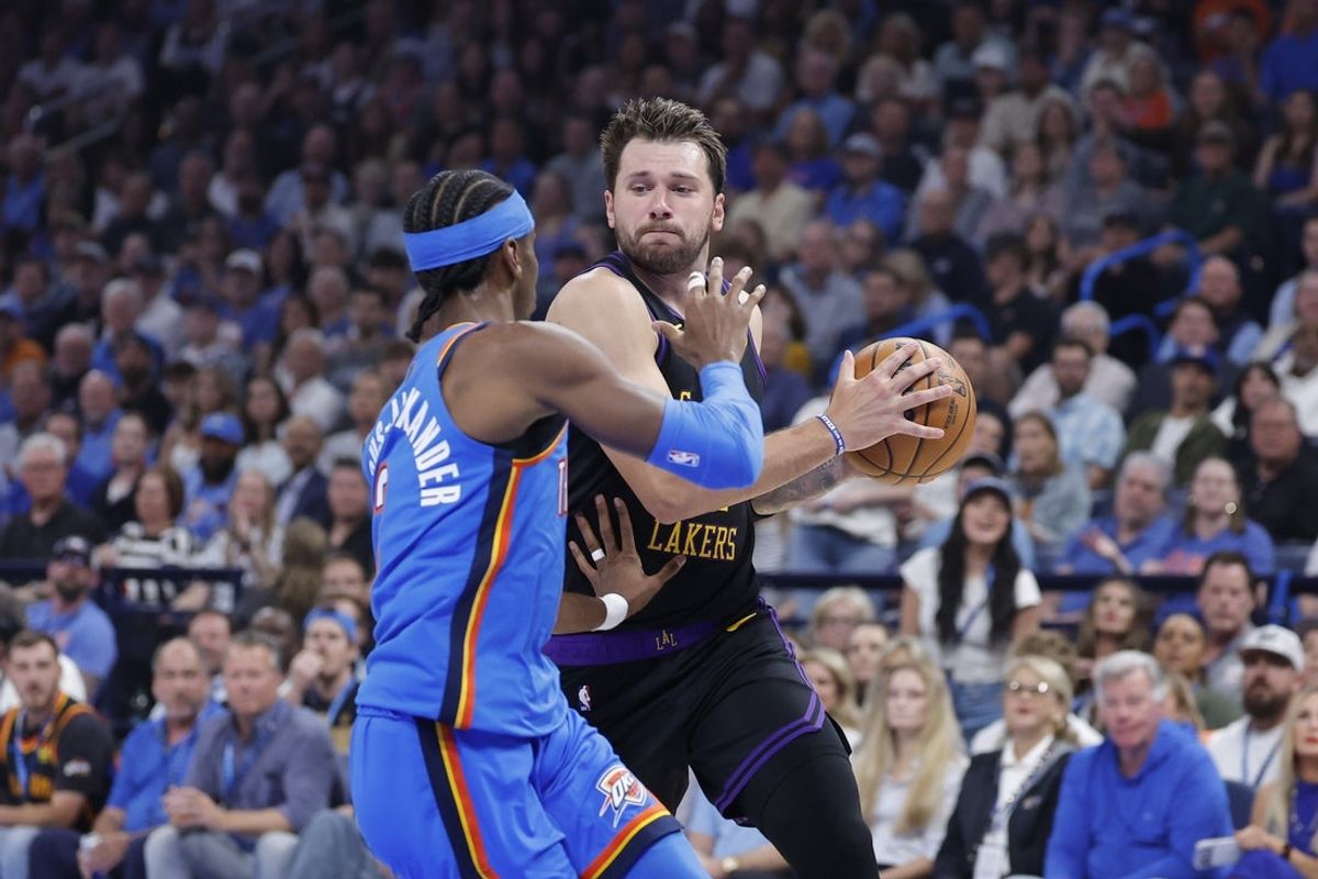 Apr 2, 2026; Oklahoma City, Oklahoma, USA; Los Angeles Lakers guard Luka Doncic (77) drives to the basket against Oklahoma City Thunder guard Shai Gilgeous-Alexander (2) during the first quarter at Paycom Center. Mandatory Credit: Alonzo Adams-Imagn Images