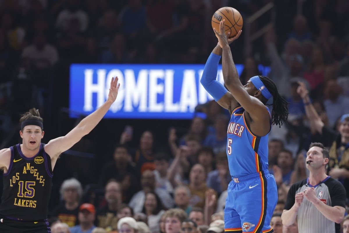 Apr 2, 2026; Oklahoma City, Oklahoma, USA; Oklahoma City Thunder guard Luguentz Dort (5) shoots a three point basket as Los Angeles Lakers guard Austin Reaves (15) defends during the first quarter at Paycom Center. Mandatory Credit: Alonzo Adams-Imagn Images