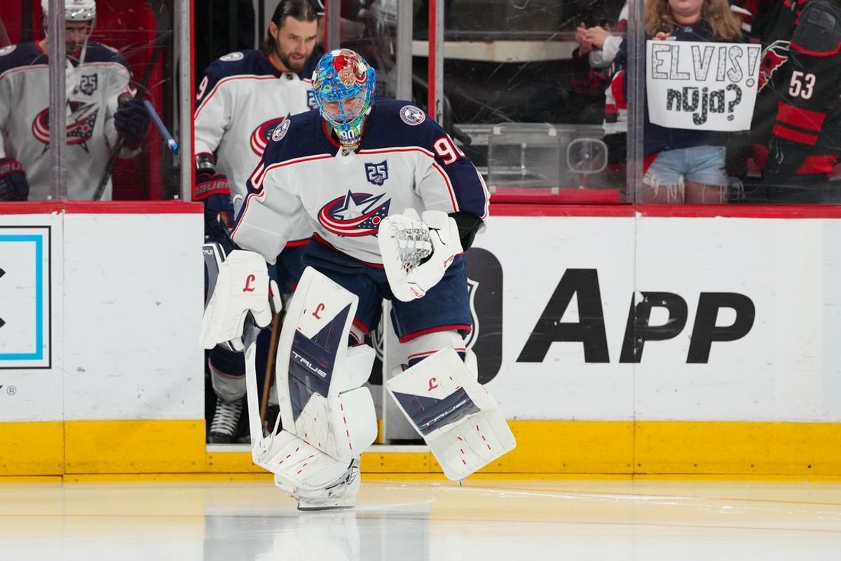 Apr 2, 2026; Raleigh, North Carolina, USA;  Columbus Blue Jackets goaltender Elvis Merzlikins (90) skates out onto the ice for the warmups before the game against the Carolina Hurricanes at Lenovo Center. Mandatory Credit: James Guillory-Imagn Images