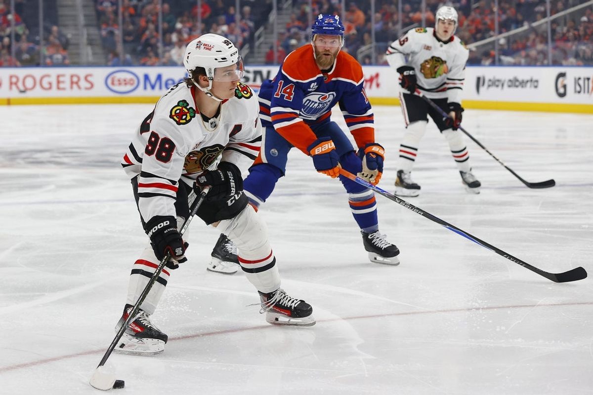 Apr 2, 2026; Edmonton, Alberta, CAN; Chicago Blackhawks forward Connor Bedard (98) takes a shot in front of Edmonton Oilers defensemen Mattias Ekholm (14)during the second period at Rogers Place. Mandatory Credit: Perry Nelson-Imagn Images