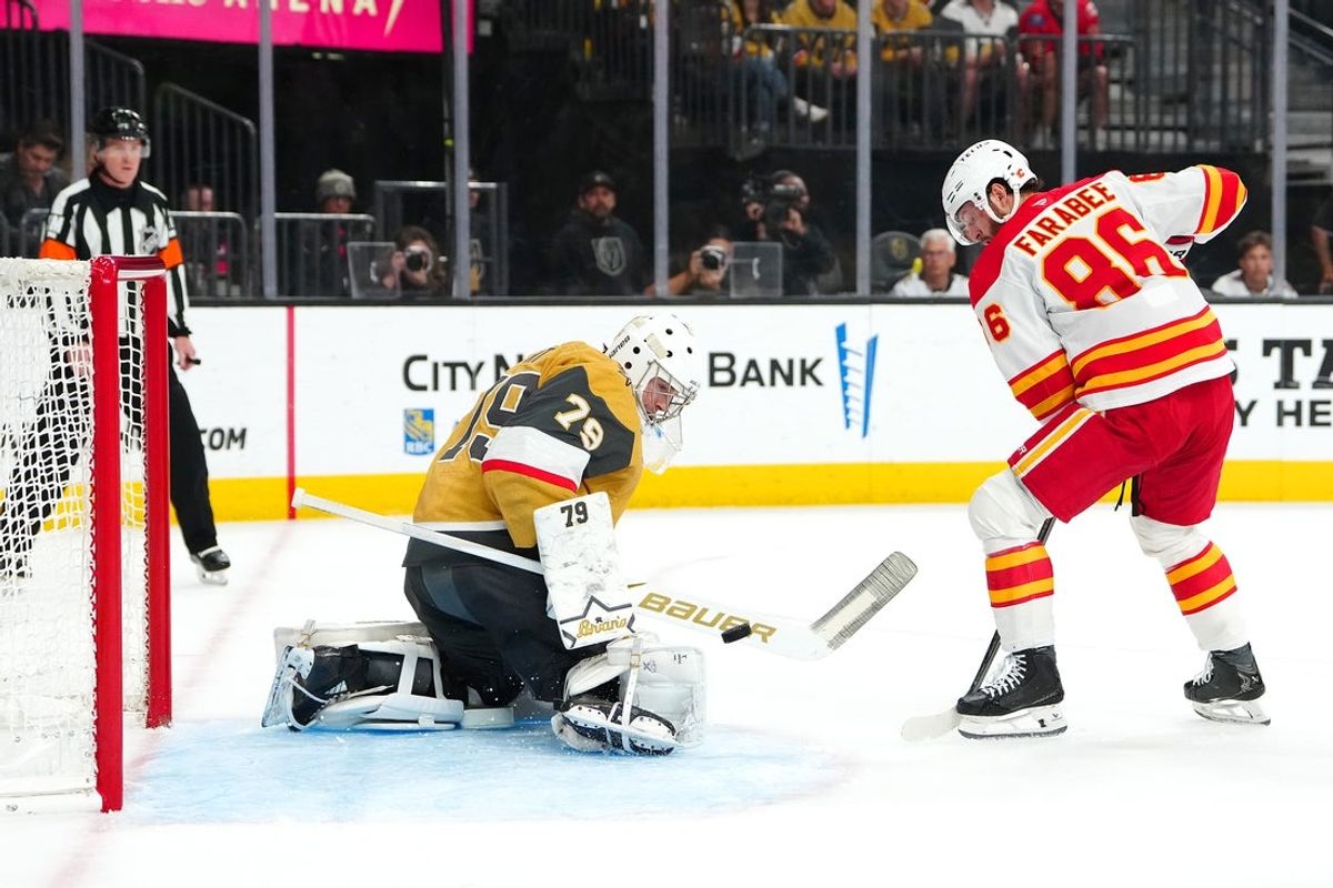 Apr 2, 2026; Las Vegas, Nevada, USA; Vegas Golden Knights goaltender Carter Hart (79) makes a save as Calgary Flames left wing Joel Farabee (86) looks for a rebound during the first period at T-Mobile Arena. Mandatory Credit: Stephen R. Sylvanie-Imagn Images