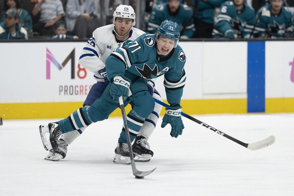Apr 2, 2026; San Jose, California, USA;  San Jose Sharks center Macklin Celebrini (71) controls the puck during the first period against Toronto Maple Leafs center Jacob Quillan (26) at SAP Center at San Jose. Mandatory Credit: Stan Szeto-Imagn Images
