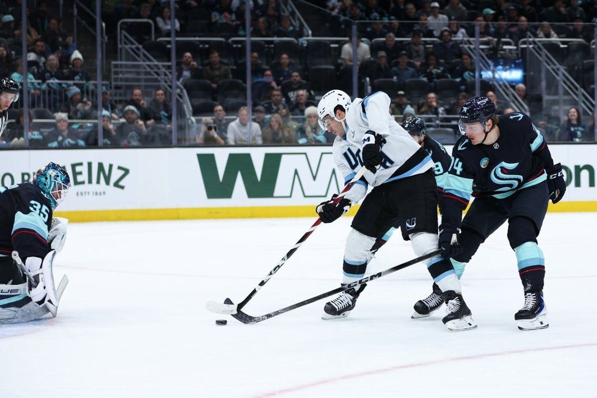 Apr 2, 2026; Seattle, Washington, USA; Utah Mammoth center Nick Schmaltz (8) attempts a shot on goal while defended by Seattle Kraken center Bobby McMann (74) in the second period at Climate Pledge Arena. Mandatory Credit: Kevin Ng-Imagn Images
