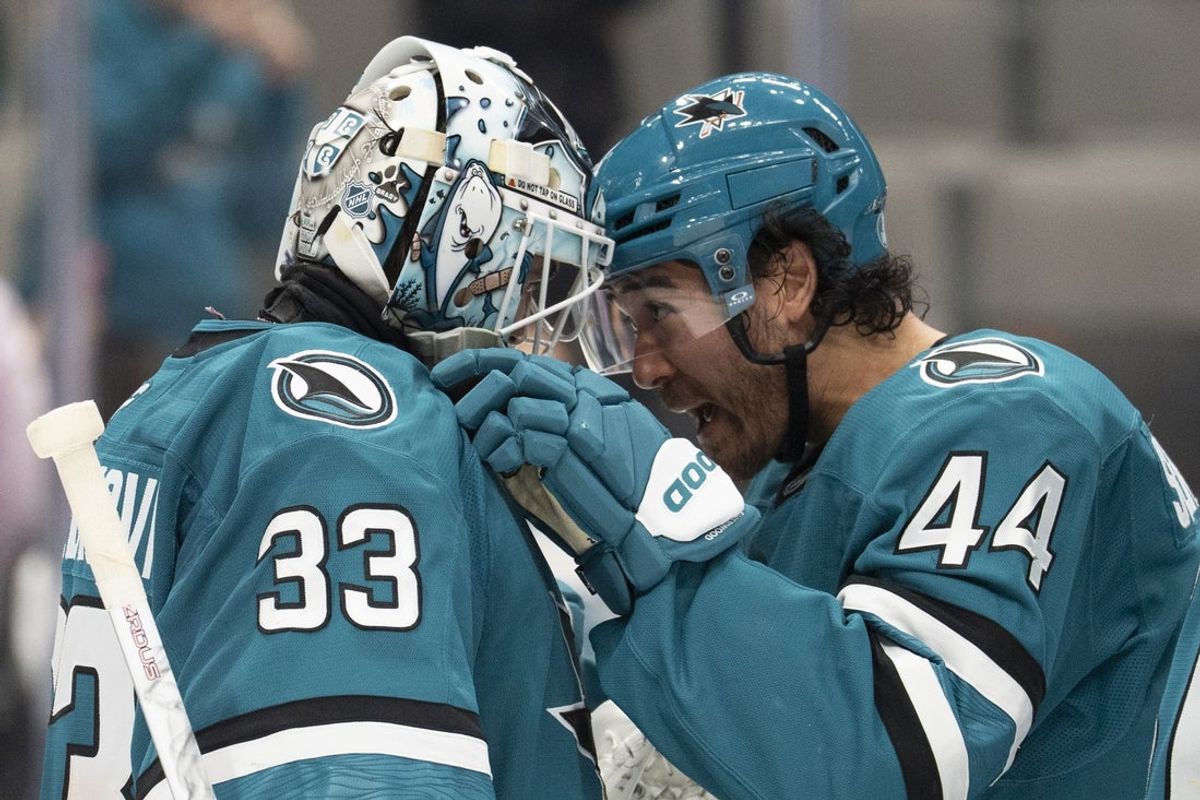 Apr 2, 2026; San Jose, California, USA;  San Jose Sharks goaltender Alex Nedeljkovic (33) and San Jose Sharks left wing Kiefer Sherwood (44) celebrate after defeating the Toronto Maple Leafs at SAP Center at San Jose. Mandatory Credit: Stan Szeto-Imagn Images