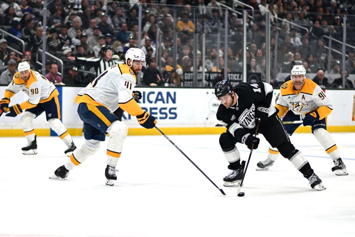 Apr 2, 2026; Los Angeles, California, USA; Los Angeles Kings right wing Alex Laferriere (14) and Nashville Predators defenseman Nicolas Hague (41) battle for the puck during the second period at Crypto.com Arena. Mandatory Credit: Griffin Hooper-Imagn Images