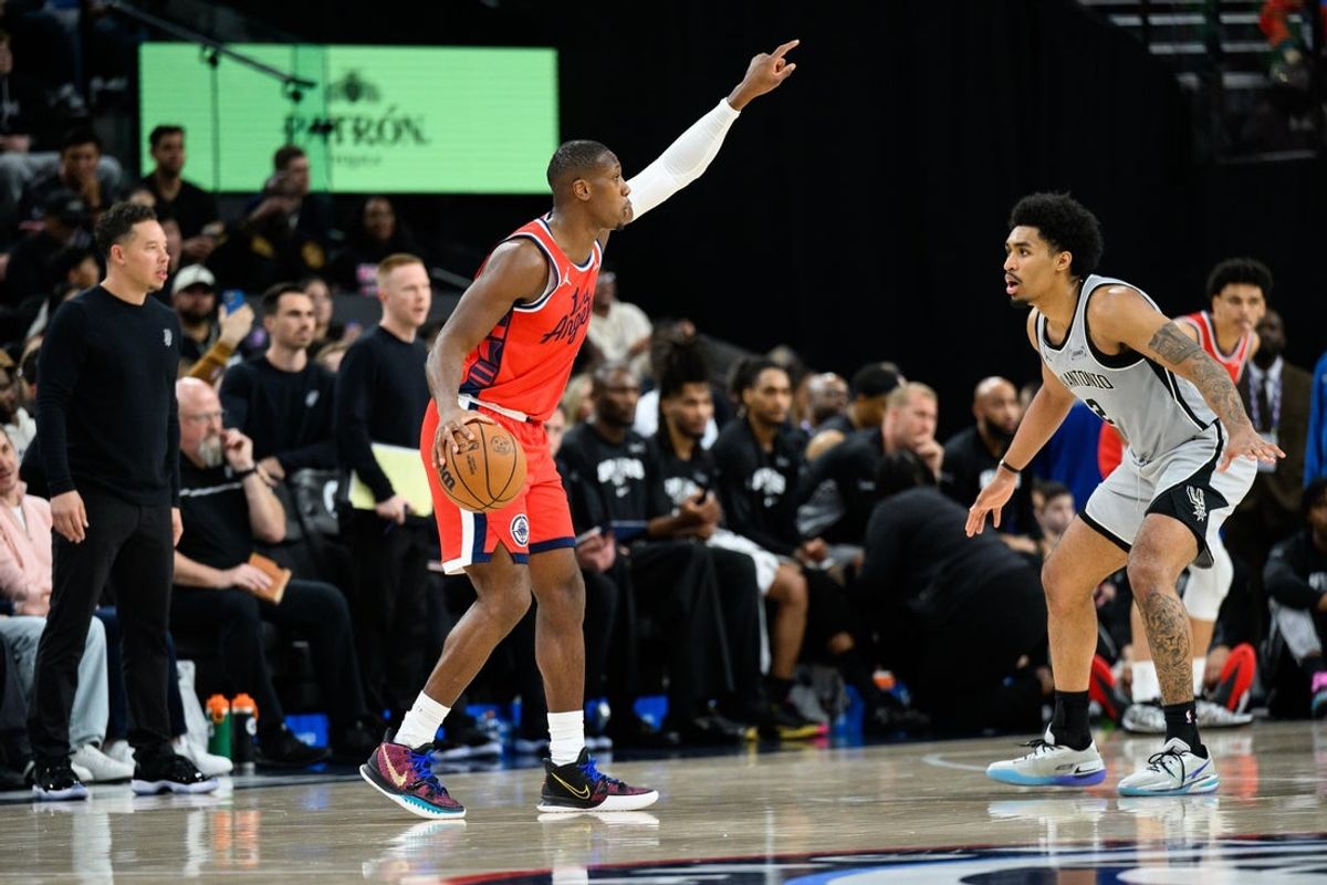 Apr 2, 2026; Inglewood, California, USA; Los Angeles Clippers guard Kris Dunn (8) gestures to teammates while under pressure from San Antonio Spurs guard Dylan Harper (2) during the second half at Intuit Dome. Mandatory Credit: William Liang-Imagn Images