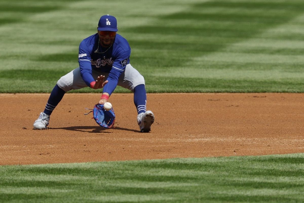 Apr 3, 2026; Washington, District of Columbia, USA; Los Angeles Dodgers shortstop Mookie Betts (50) fields a ground ball by Washington Nationals second baseman Luis García Jr. (not pictured) during the first inning at Nationals Park. Mandatory Credit: Geoff Burke-Imagn Images