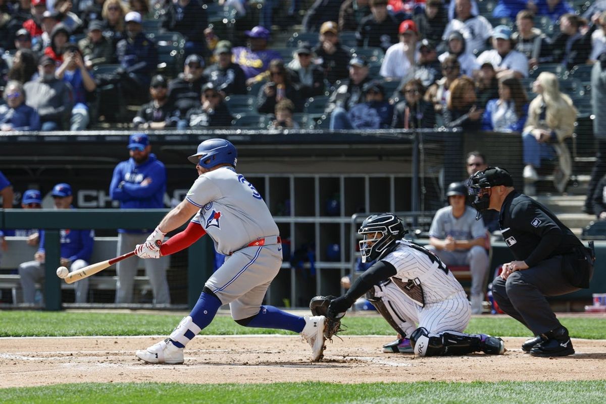 Apr 3, 2026; Chicago, Illinois, USA; Toronto Blue Jays catcher Alejandro Kirk (30) hits an RBI-double against the Chicago White Sox during the second inning at Rate Field. Mandatory Credit: Kamil Krzaczynski-Imagn Images