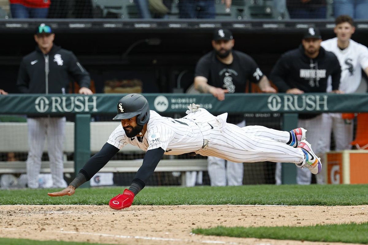 Apr 3, 2026; Chicago, Illinois, USA; Chicago White Sox center fielder Derek Hill (25) slides to score against the Toronto Blue Jays during the 10th inning at Rate Field. Mandatory Credit: Kamil Krzaczynski-Imagn Images