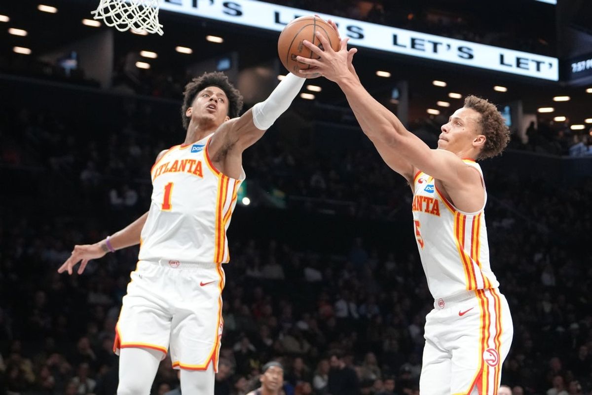 Apr 3, 2026; Brooklyn, New York, USA; Atlanta Hawks forward Jalen Johnson (1) and Atlanta Hawks guard Dyson Daniels (5) grab a rebound against the Brooklyn Nets during the first half at Barclays Center. Mandatory Credit: Gregory Fisher-Imagn Images