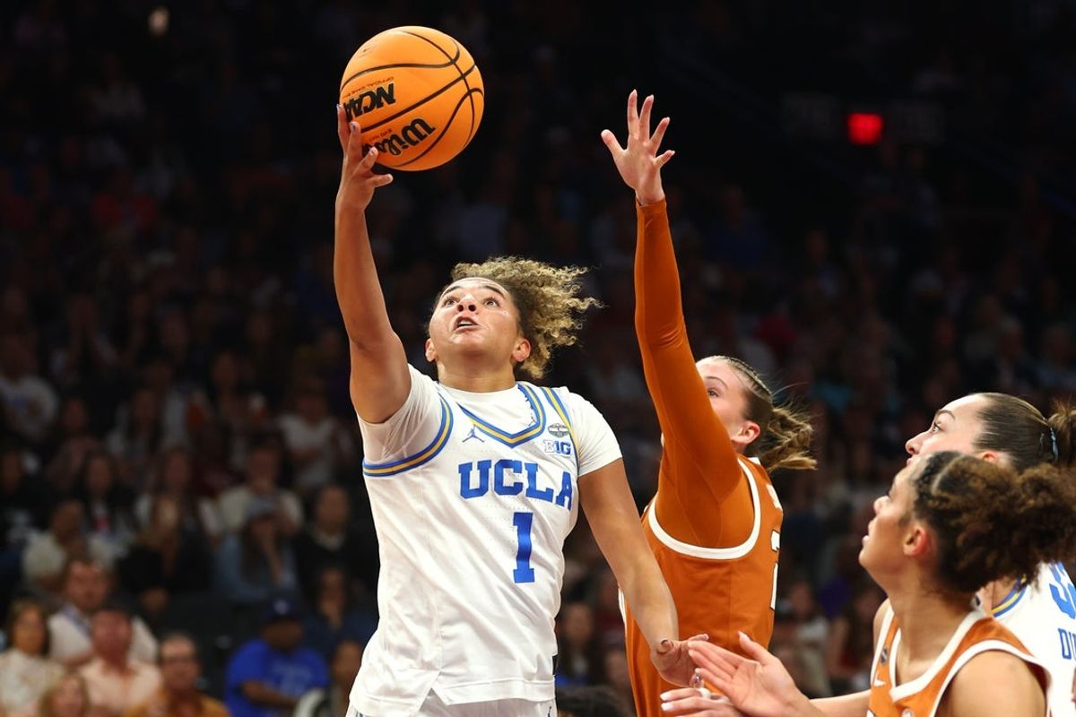 Apr 3, 2026; Phoenix, AZ, USA; UCLA Bruins guard Kiki Rice (1) shoots against Texas Longhorns guard Ashton Judd (21) in the first half during a semifinal of the Final Four of the women's 2026 NCAA Tournament at Mortgage Matchup Center. Mandatory Credit: Mark J. Rebilas-Imagn Images