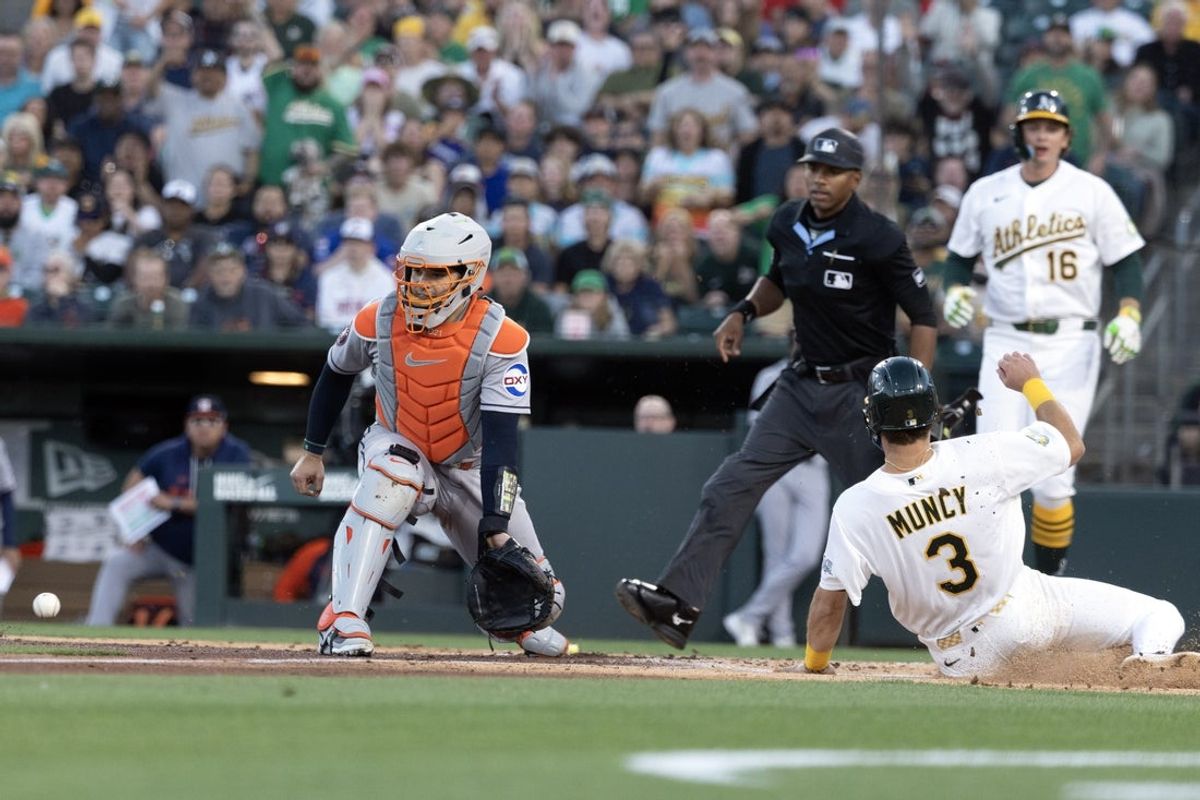 Apr 3, 2026; West Sacramento, California, USA; Athletics third baseman Max Muncy (3) slides safely home ahead of the relay to Houston Astros catcher Yainer Diaz (left) during the second inning at Sutter Health Park. Mandatory Credit: D. Ross Cameron-Imagn Images