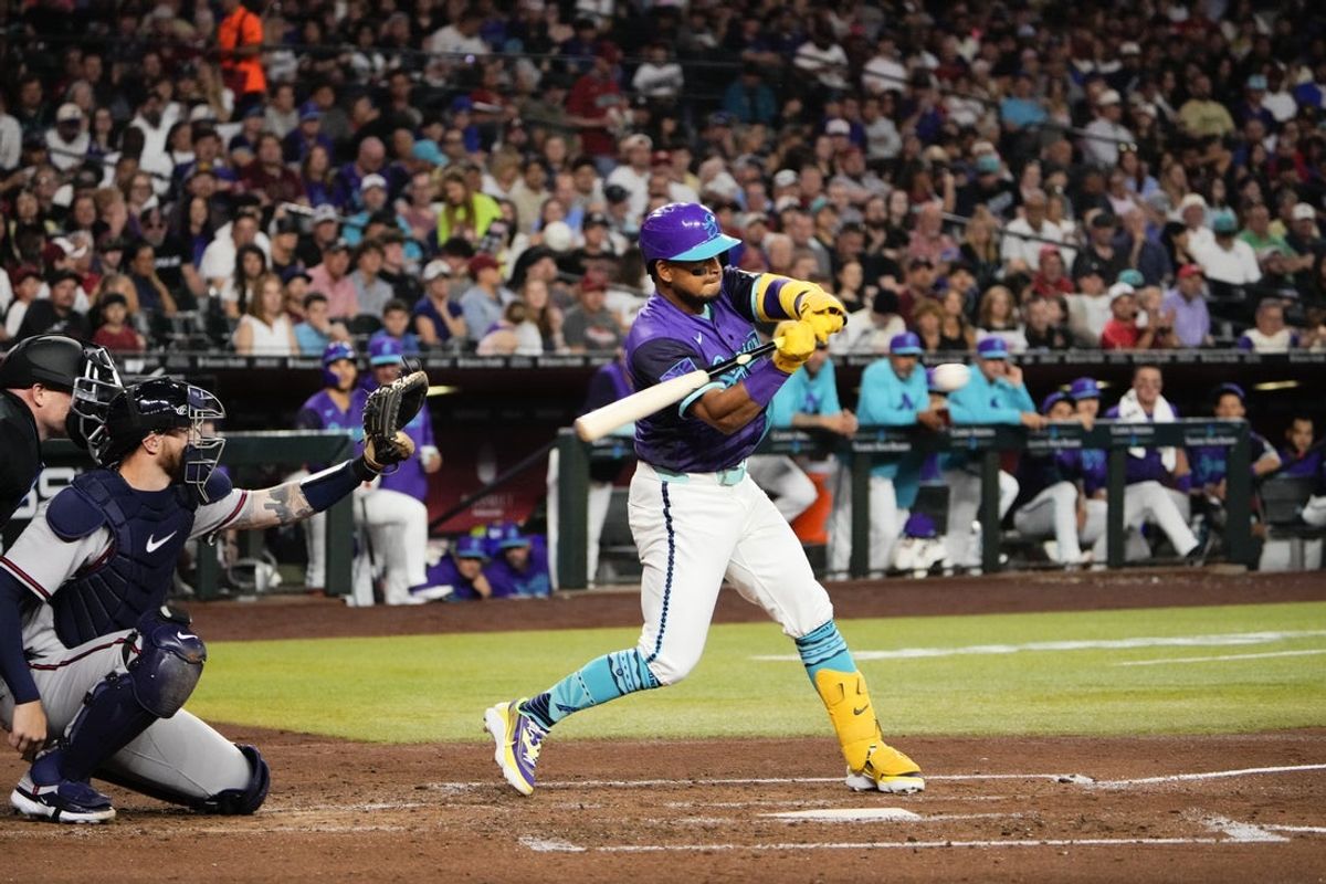 Apr 3, 2026; Phoenix, Arizona, USA; Arizona Diamondbacks catcher Gabriel Moreno (14) hits during the fourth inning of the game against the Atlanta Braves at Chase Field. Mandatory Credit: Arianna Grainey-Imagn Images