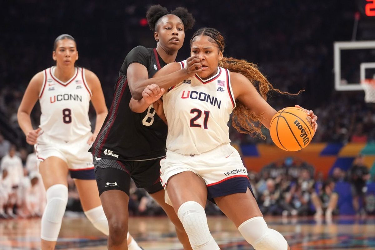 Connecticut Huskies forward Sarah Strong (21) drives in to the lane as South Carolina Gamecocks forward Joyce Edwards (8) defends during their NCAA Women's Final Four semifinal game at Mortgage Matchup Center on April 3, 2026.