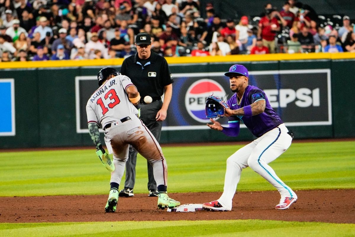 Apr 3, 2026; Phoenix, Arizona, USA; Atlanta Braves right fielder Ronald Acuna Jr. (13) tags back as Arizona Diamondbacks second baseman Ketel Marte (4) grabs the ball during the sixth inning of the game against the Atlanta Braves at Chase Field. Mandatory Credit: Arianna Grainey-Imagn Images