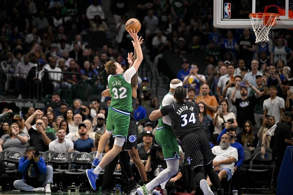Apr 3, 2026; Dallas, Texas, USA; Dallas Mavericks forward Cooper Flagg (32) makes a jump shot over Orlando Magic forward Jamal Cain (8) for his fiftieth point of the night during the fourth quarter at the American Airlines Center. Mandatory Credit: Jerome Miron-Imagn Images
