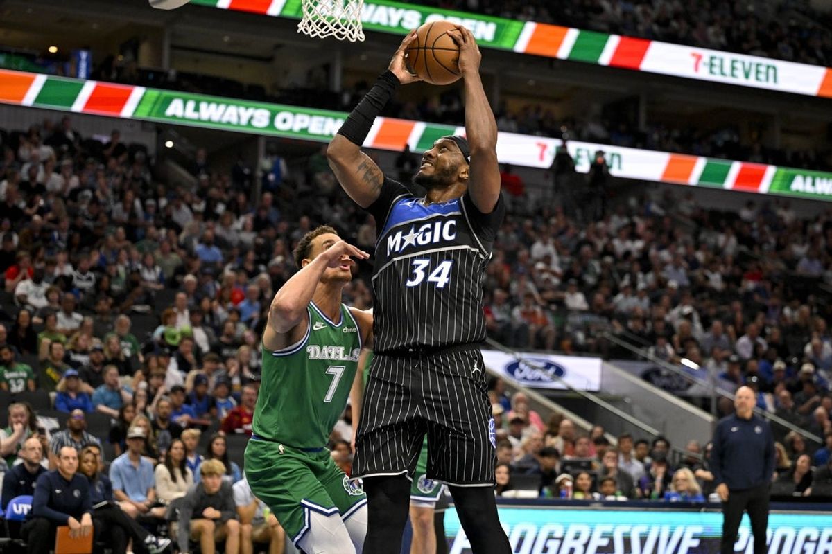 Apr 3, 2026; Dallas, Texas, USA; Orlando Magic center Wendell Carter Jr. (34) shoots the ball over Dallas Mavericks forward Dwight Powell (7) during the second half at the American Airlines Center. Mandatory Credit: Jerome Miron-Imagn Images