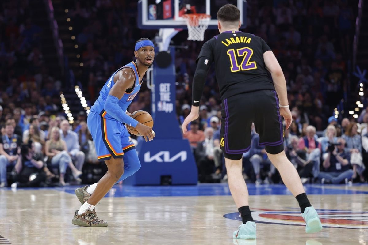 Apr 2, 2026; Oklahoma City, Oklahoma, USA; Oklahoma City Thunder guard Shai Gilgeous-Alexander (2) dribbles down the court as Los Angeles Lakers forward Jake LaRavia (12) defends during the second half at Paycom Center. Mandatory Credit: Alonzo Adams-Imagn Images