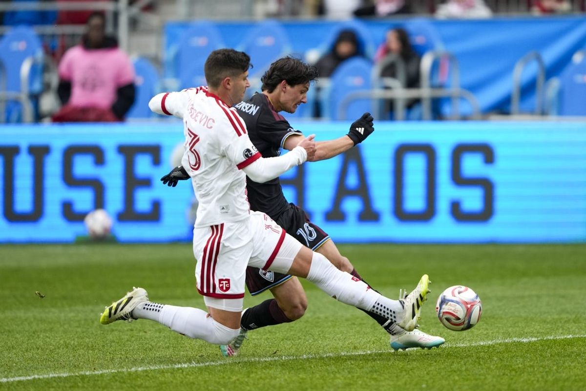 Apr 4, 2026; Toronto, Ontario, CAN;  Toronto FC defender Benjamín Kuscevic (13) battles for the ball against Colorado Rapids midfielder Paxten Aaronson (10) during the first half at BMO Field. Mandatory Credit: Kevin Sousa-Imagn Images