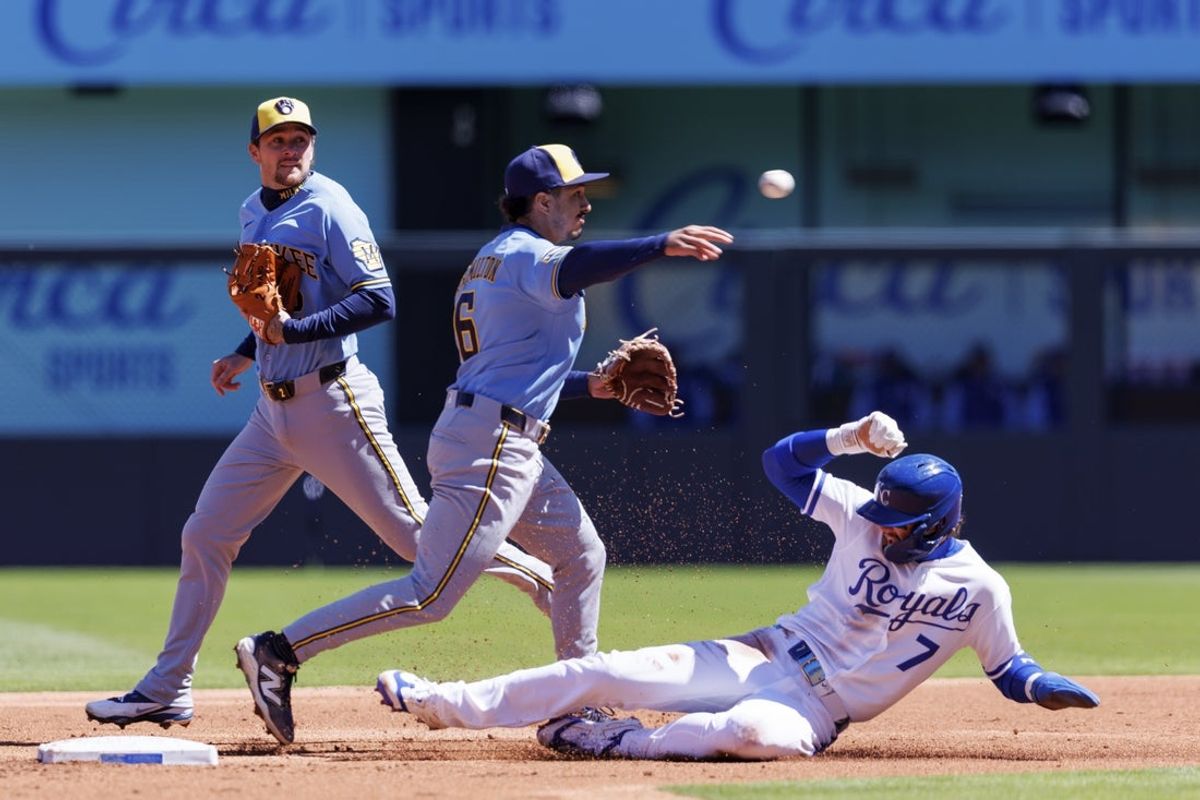 Apr 4, 2026; Kansas City, Missouri, USA; Milwaukee Brewers second baseman David Hamilton (6) throws to first base over Kansas City Royals shortstop Bobby Witt Jr. (7) during the first inning at Kauffman Stadium. Mandatory Credit: William Purnell-Imagn Images