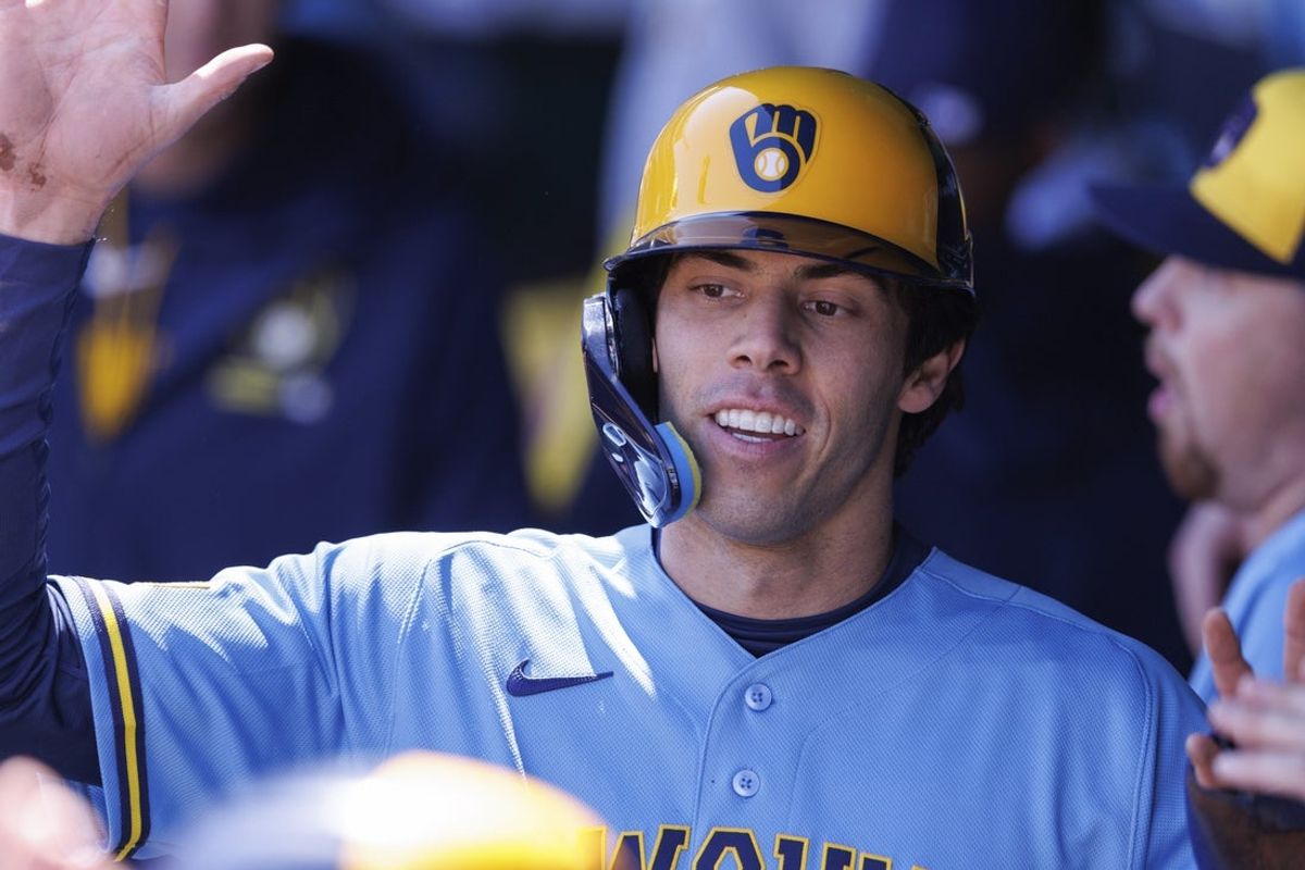Apr 4, 2026; Kansas City, Missouri, USA; Milwaukee Brewers left fielder Christian Yelich (22) celebrates in the dugout after scoring during the first inning against the Kansas City Royals at Kauffman Stadium. Mandatory Credit: William Purnell-Imagn Images