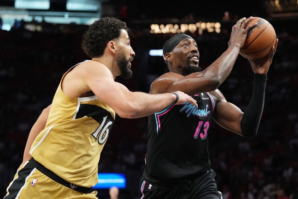 Apr 4, 2026; Miami, Florida, USA;  Miami Heat center Bam Adebayo (13) drives to the basket as Washington Wizards forward Anthony Gill (16) defends during the first half at Kaseya Center. Mandatory Credit: Jim Rassol-Imagn Images