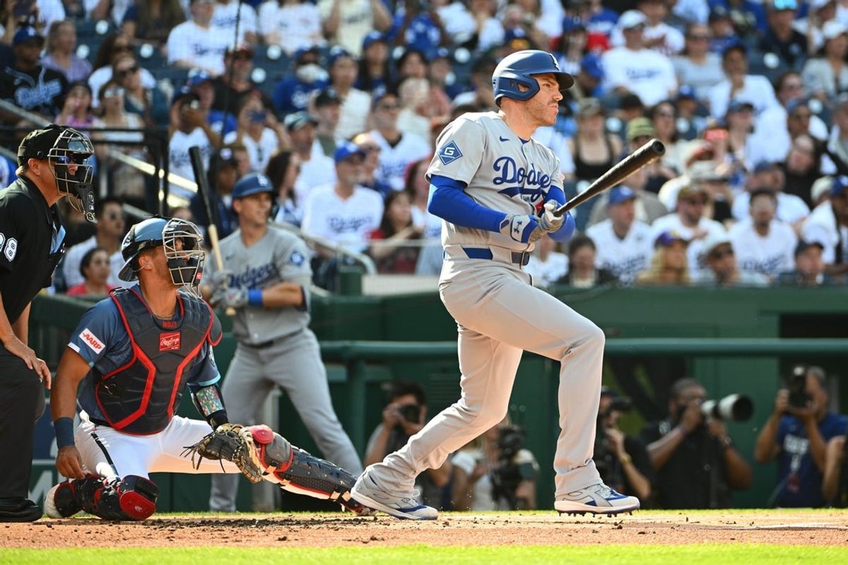 Apr 4, 2026; Washington, District of Columbia, USA; Los Angeles Dodgers first baseman Freddie Freeman (5) hits a two RBI double against the Washington Nationals during the first inning at Nationals Park. Mandatory Credit: Brad Mills-Imagn Images