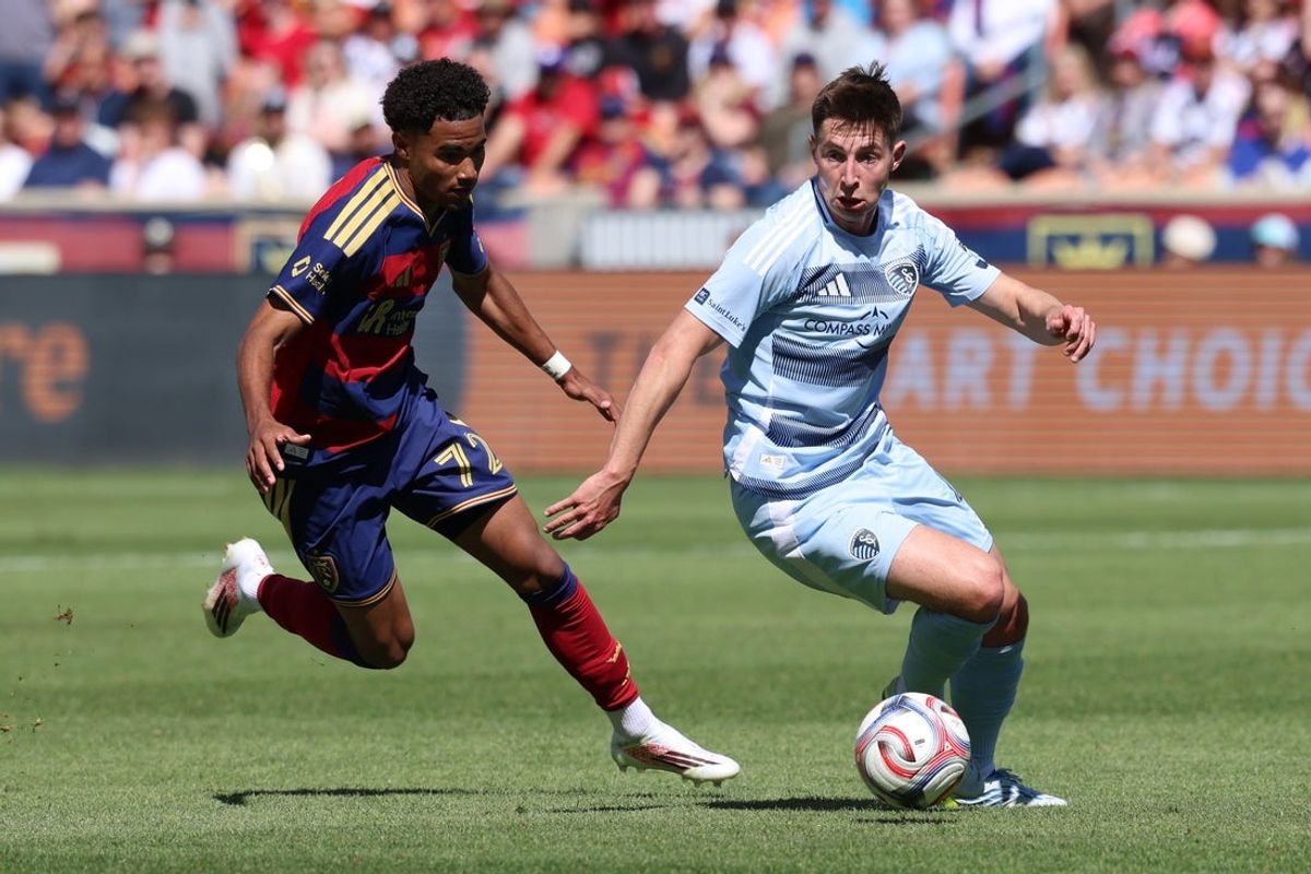 Apr 4, 2026; Sandy, Utah, USA; Sporting Kansas City midfielder Lasse Johnsen (4) moves the ball against Real Salt Lake midfielder Zavier Gozo (72) during the first half at America First Field. Mandatory Credit: Rob Gray-Imagn Images