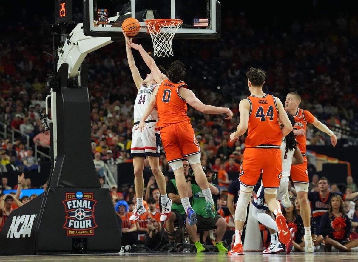 Apr 4, 2026; Indianapolis, IN, USA;  Connecticut Huskies guard Braylon Mullins (24) shoots against Illinois Fighting Illini forward David Mirkovic (0) in the first half during a semifinal of the Final Four of the men's 2026 NCAA Tournament at Lucas Oil Stadium. Mandatory Credit: Robert Deutsch-Imagn Images