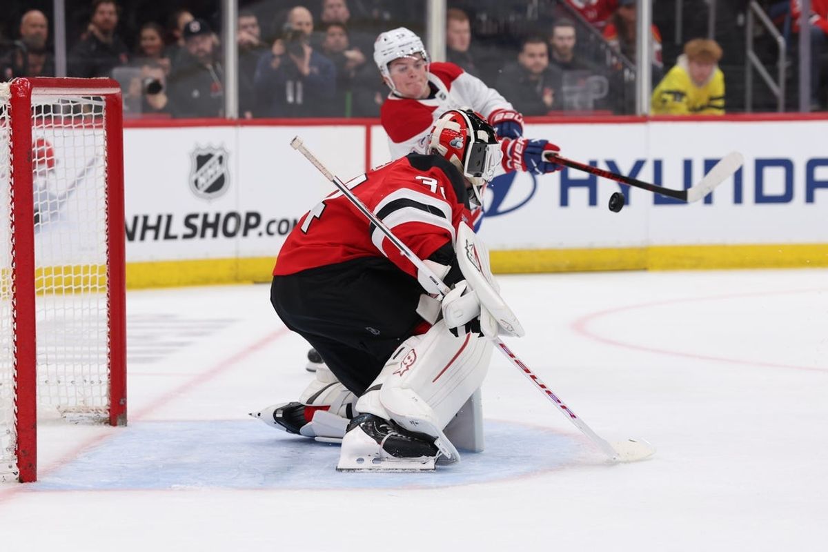 Apr 4, 2026; Newark, New Jersey, USA; Montréal Canadiens right wing Cole Caufield (13) swipes at the puck in front of New Jersey Devils goaltender Jake Allen (34) during the first period at Prudential Center. Mandatory Credit: Thomas Salus-Imagn Images