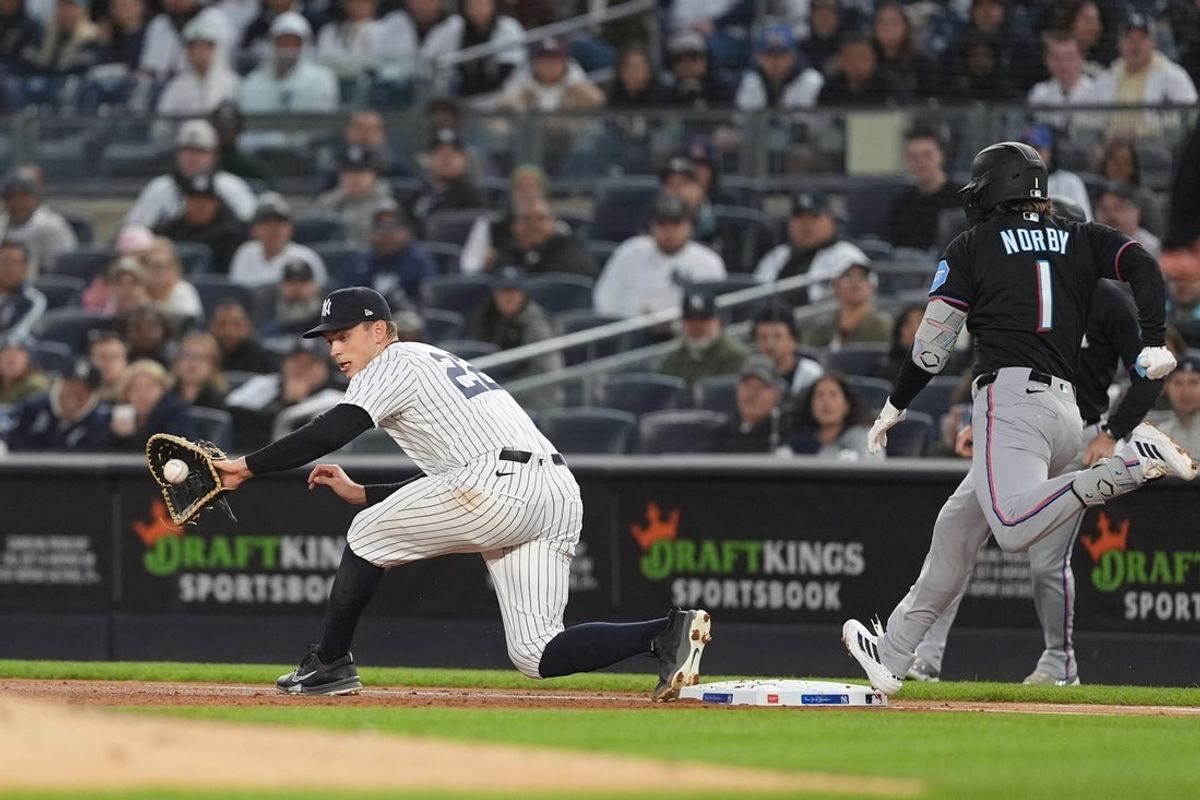 Apr 4, 2026; Bronx, New York, USA; New York Yankees first baseman Ben Rice (22) catches a throw to record an out against Miami Marlins first baseman Connor Norby (1) during the first inning at Yankee Stadium. Mandatory Credit: Gregory Fisher-Imagn Images