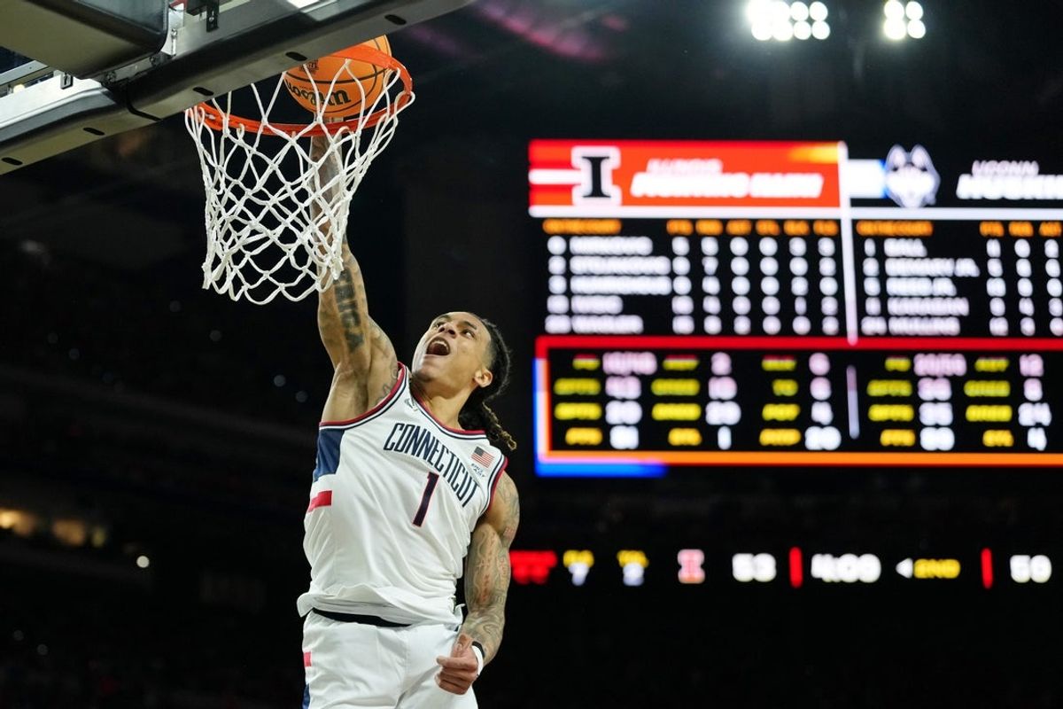 Apr 4, 2026; Indianapolis, IN, USA; UConn Huskies guard Solo Ball (1) dunks against the Illinois Fighting Illini during the second half of a semifinal of the Final Four of the men's 2026 NCAA Tournament at Lucas Oil Stadium. Mandatory Credit: Bob Donnan-Imagn Images