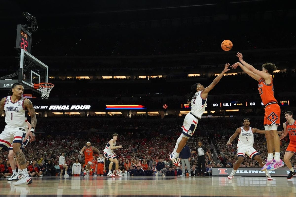Apr 4, 2026; Indianapolis, IN, USA;  Illinois Fighting Illini guard Keaton Wagler (23) shoots over Connecticut Huskies guard Silas Demary Jr. (2) in the second half during a semifinal of the Final Four of the men's 2026 NCAA Tournament at Lucas Oil Stadium. Mandatory Credit: Robert Deutsch-Imagn Images