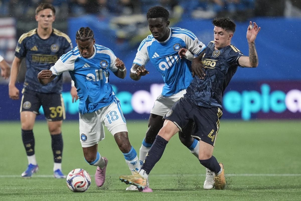 Apr 4, 2026; Charlotte, North Carolina, USA; Charlotte FC forward Kerwin Vargas (18) tries to maintain control of the ball challenged by Philadelphia Union midfielder Jovan Lukic (4) during the first half  at Bank of America Stadium. Mandatory Credit: Jim Dedmon-Imagn Images